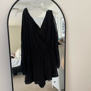 Dressy black romper with two cut outs in the long sheer sleeves